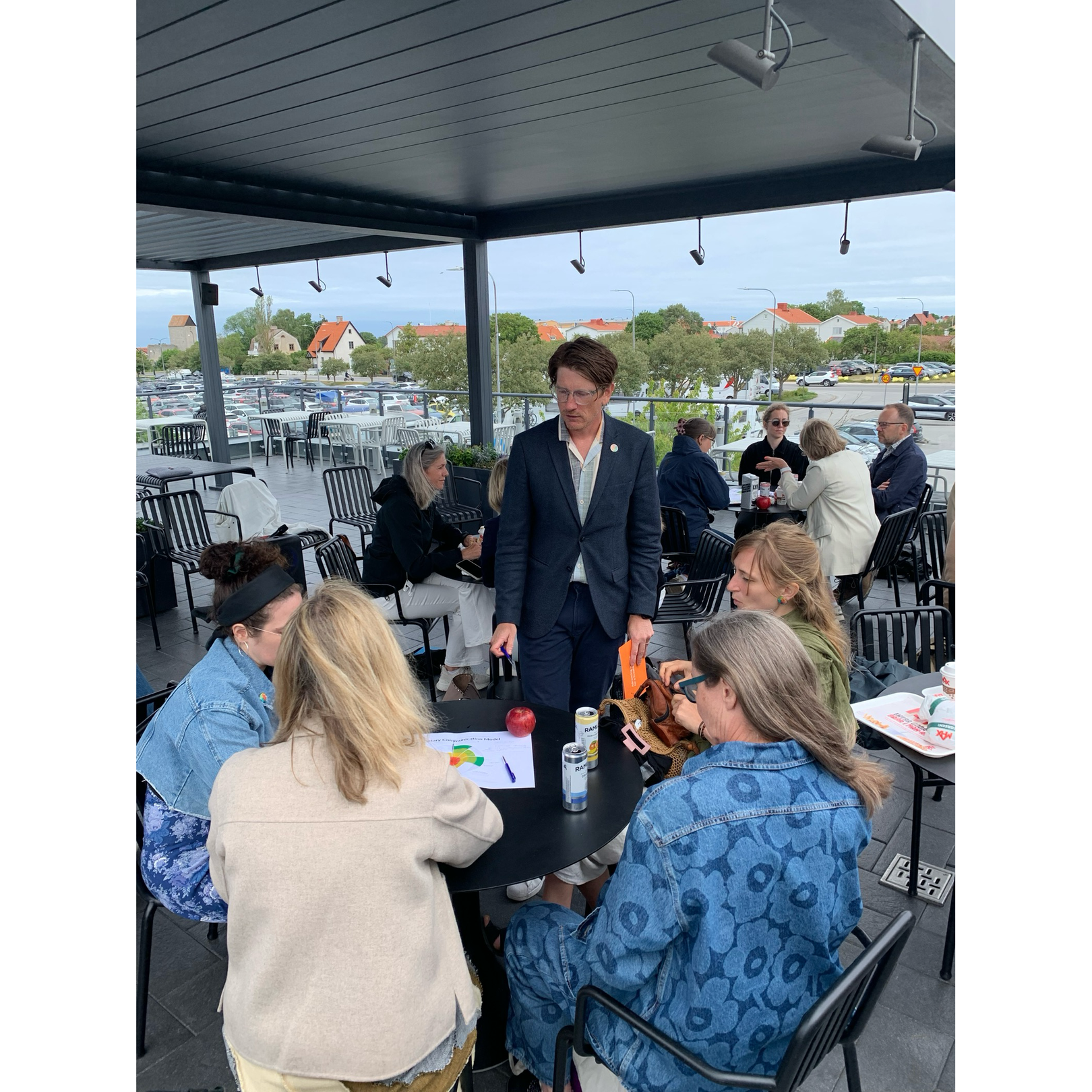 People sitting around tables discussing during workshop